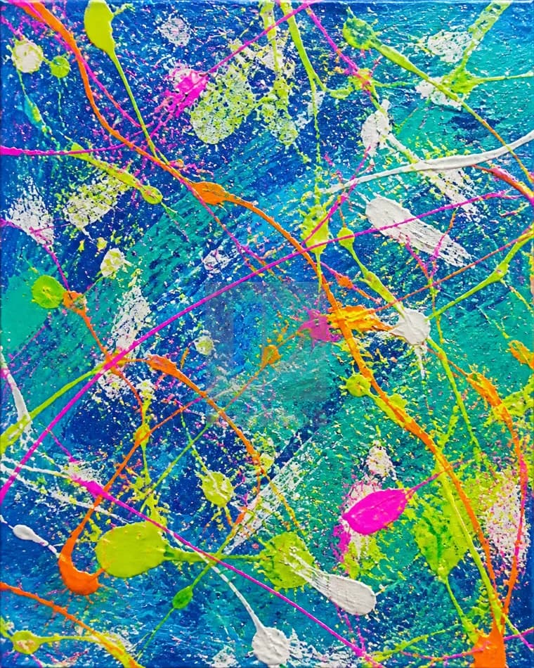 Electric blue canvas covered with vivid paint splashes